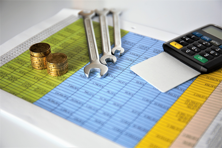 Calculator, coins, and wrenches on a chart of facility maintenance needs. The need to optimize your maintenance budget has never been greater.