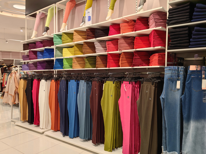 Colorful leggings displayed in a retail store. Athleisure store facility services ensure these upscale outlets convey comfor.