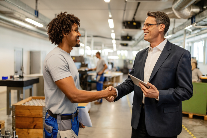 A facility manager and a maintenance partner reviewing service documentation together inside a retail store. the start of a strong facility maintenance partnership.